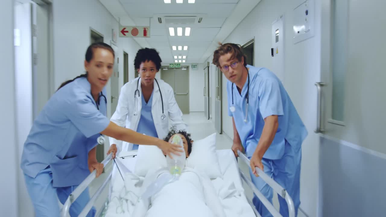 Medical team rushing a hospital bed down a corridor